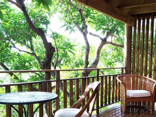 Furnished wooden terrace beneath the mango trees